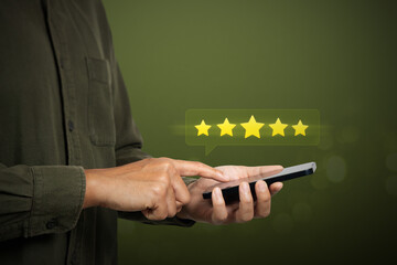 Service rating, satisfaction and feedback concept. A man holding mobilephone giving a five star rating for customer experience with service