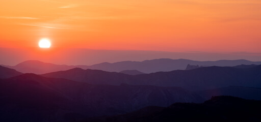 The Colorful sunset over the mountain hills