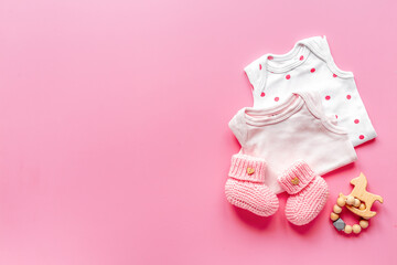 Obraz na płótnie Canvas Flat lay of pink baby clothing and accessories. Kids bodysuit and shoes flat lay