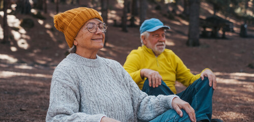 Head shot portrait close up of two old seniors middle age people meditating and relaxing in the...