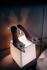 Bride's white trendy brand wedding shoes decorated with sequins close-up