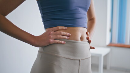 Closeup woman rotating waist training home. Unknown lady belly sport exercises
