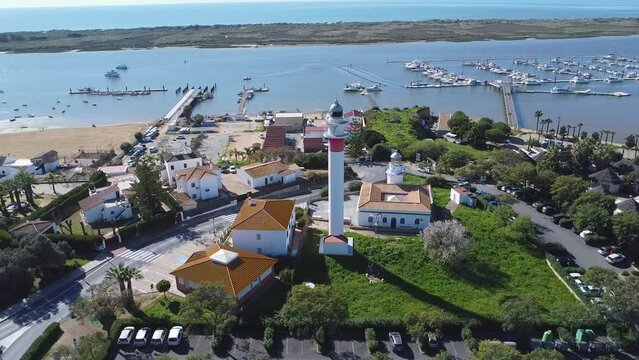 Lighthouse tower in the beach village El Rompido, in the municipality of Cartaya, Huelva, Andalusia, Spain. This lighthouse dates back to 1975, replacing the one that existed since 1861