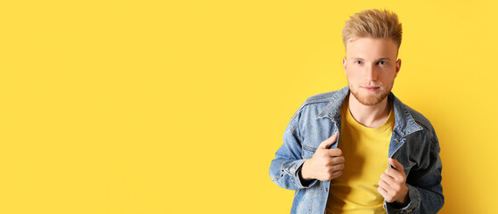 Portrait of stylish young man on yellow background with space for text