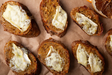 Toasts with layer of melted cheese, rustic comfort food