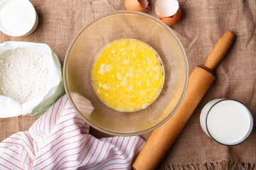 Home Baking - whisking eggs for homemade cake. Rustic recipe with eggs, wholegrain flour, sugar and kefir