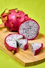 Red dragon fruit Set with appetizing serving on green background. Top view