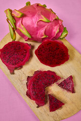 Red dragon fruit Set with appetizing serving on pink background. Top view