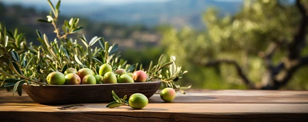 Poster Im Rahmen Empty rustic old wooden boards table copy space with olive trees in background, some fruits on desk © Dipankar