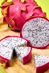 Red dragon fruit Set with appetizing serving on green background. Top view