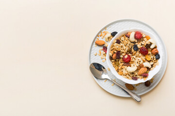 Cooking a wholesome breakfast. Granola with Various dried fruits and nuts in a bowl. The concept of a healthy dessert. Flat lay, top view with copy space