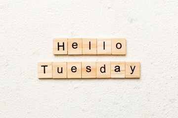 hello Tuesday word written on wood block. hello Tuesday text on cement table for your desing, concept