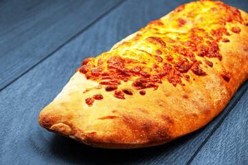 pita bread with cheese on a blue background. pastries covered with cheese on a wooden background	