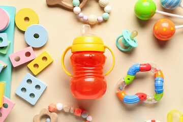 Wooden educational toys blocks with baby bottle on orange background