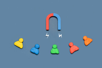 Magnet with lightnings and group of customers on blue background. Marketing concept