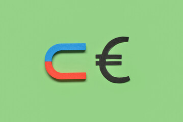 Magnet with euro sign on green background. Attracting investments concept
