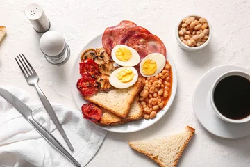  Plate with tasty English breakfast and cup of coffee on white background © Pixel-Shot