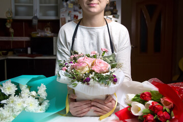 Florist background. A female florist works on a beautiful bouque