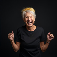 Smiling old woman wearing BLACK T-Shirt Mockup on black studio background