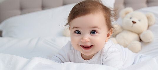 Cute happy 7 month baby girl in in bed