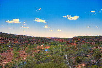 View of the valley of the Murchison River, with green trees and red rocks, from the Ross Graham...