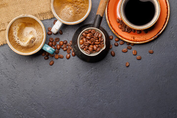 Roasted coffee beans and various espresso coffee cup