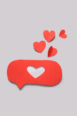 Red paper speech bubble with hearts on grey background. Valentines Day celebration