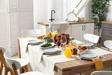 Festive dining table with tasty food for Thanksgiving Day in kitchen