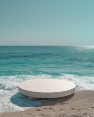 Fototapeta na wymiar Three round marble platforms resting on a sandy beach as the backdrop of foamy sea waves creates a serene yet dynamic setting.