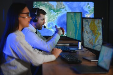 Center of dispatching maintenance. Portrait of cheerful woman and man working via headset...