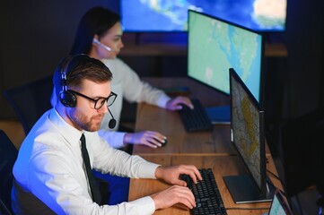 Center of dispatching maintenance. Portrait of cheerful woman and man working via headset...