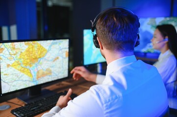 Center of dispatching maintenance. Portrait of cheerful woman and man working via headset...