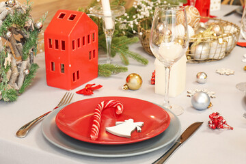 Festive table setting with beautiful Christmas decorations, closeup