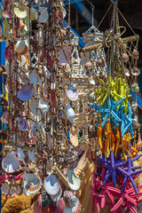 Background with ornamental shells and souvenirs hanging in the port of Rhodes, Greece - 740157760