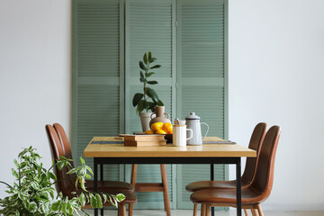 Interior of room with dining table and folding screen