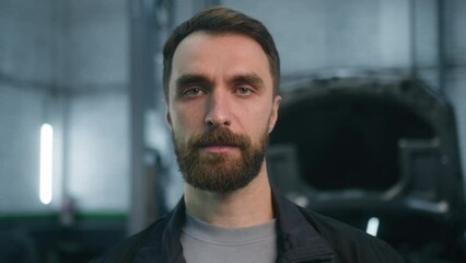 Adult caucasian man in work uniform male professional auto mechanic automotive engineer repairman looking to camera serious face confident guy small automobile business owner repair car truck service