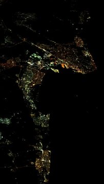 City night lights view from satellite, coastline and harbor, vertical video animation based on image by Nasa