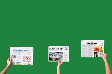 Women with newspapers on green background