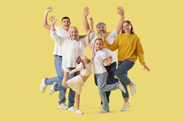 Big family jumping on yellow background