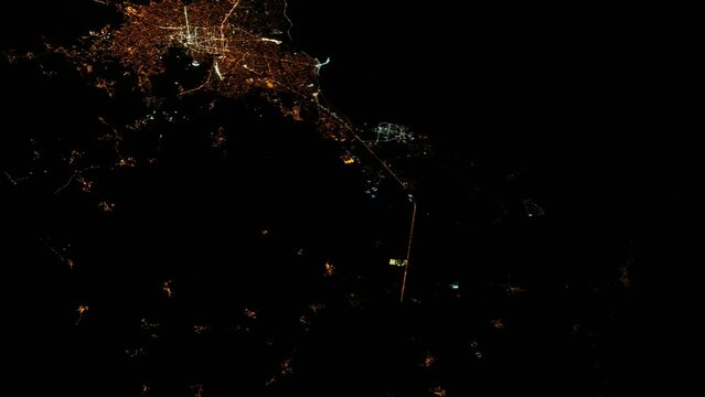 City night lights view from satellite, coastline and harbor, animation based on image by Nasa