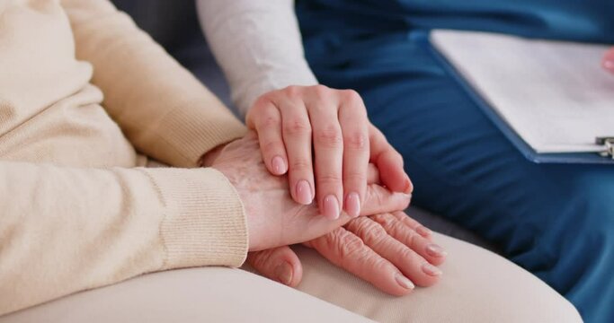 Hand clap gentle gesture close up, senior and young person in considerate, kindly caring emotion. Nurse, caregiver feeling, showing, expressing sympathy to old woman, patient support to comfort, relax