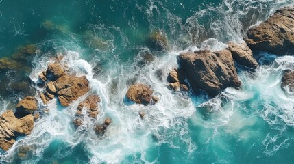 Fototapeta premium A stunning aerial view of the ocean and rocks. Perfect for travel and nature concepts