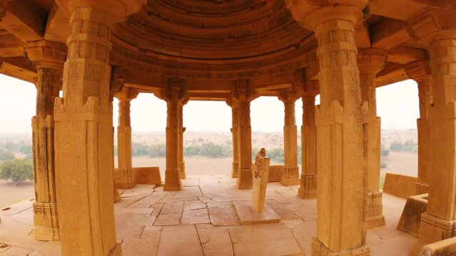 4K Wide angle dolly in shot of pillars of the cenotaphs at Jaisalmer, Rajasthan, India. Cenotaphs made from sandstones in Jaisalmer. Carvings on pillars of historical architecture.