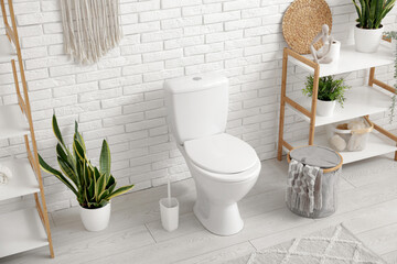 Interior of light bathroom with ceramic toilet bowl and houseplants - obrazy, fototapety, plakaty