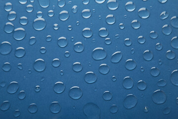 Water drops on dark blue background. Space for text