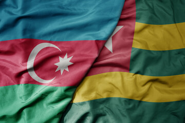 big waving national colorful flag of togo and national flag of azerbaijan.