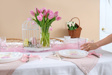 Female hand with dining table served for International Women's Day celebration