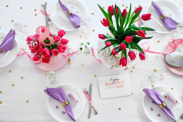 Elegant table setting with tulip flowers for International Women's Day celebration