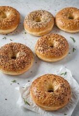 Assorted Seeded Bagels on White Background