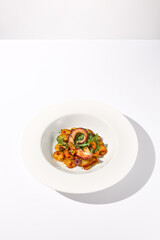 Grilled Octopus Tentacles with Potato Gratin Isolated on White Background